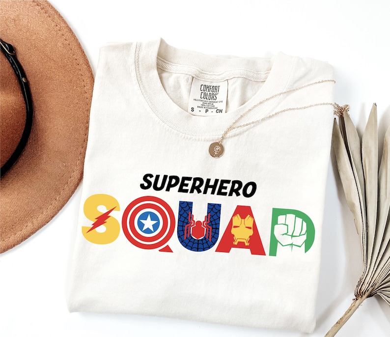 a hat, sunglasses, and t - shirt with the word superhero squad on it
