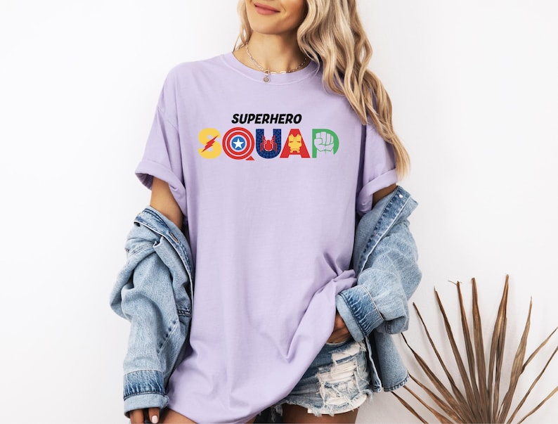 a woman wearing a purple shirt that says superhero squad