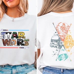 May include: White t-shirt with a Star Wars graphic on the front and a retro-style graphic of Star Wars characters on the back. The front graphic features the word "STAR WARS" with images of characters from the movie series.