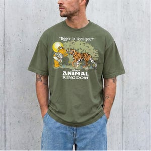 A man wearing a green t-shirt with a cartoon image of Tigger and Winnie the Pooh from the Disney animated film "Animal Kingdom".