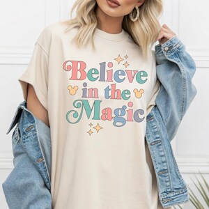 a woman wearing a t - shirt that says believe in the magic