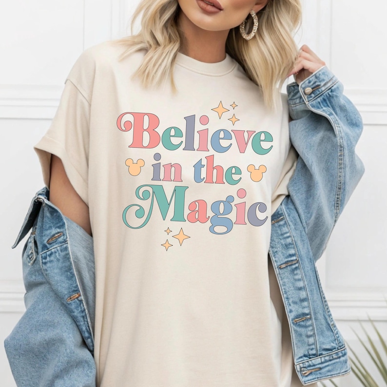 a woman wearing a t - shirt that says believe in the magic