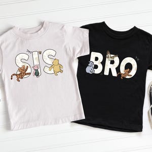 a pair of black and white tshirts with winnie the pooh on them