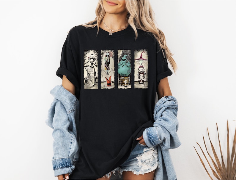 a woman wearing a black t - shirt with a star wars scene on it