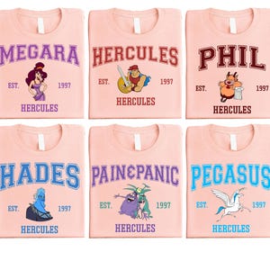a set of four pink t - shirts with cartoon characters on them