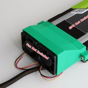 May include: A green 3D printed fan shroud for a graphics card. The shroud has two fan mounts and is designed to direct airflow over the graphics card. The text "GPU Not Included" and "Fan Not Included" is printed on the shroud.