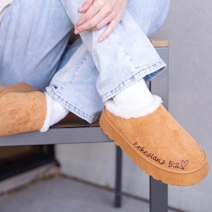 lifestyle photo of cozy scripture slippers with warm shearling lining and engraved Bible verse.
