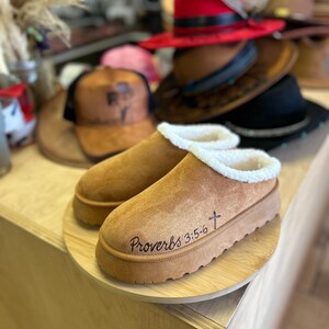 Side view of hand burned brown suede slip-on clog slippers with shearling trim and Proverbs 3:5-6 Bible verse