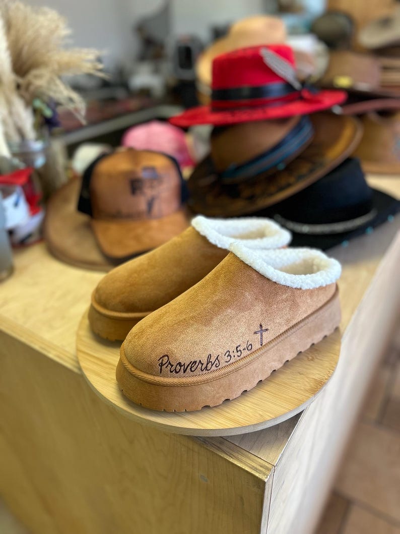 Side view of hand burned brown suede slip-on clog slippers with shearling trim and Proverbs 3:5-6 Bible verse