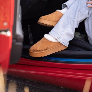lifestyle photo of cozy scripture slippers with warm shearling lining and engraved Bible verse.