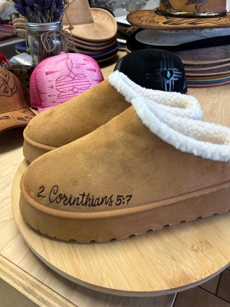 Side view of 2 Corinthians 5:7 engraved Bible verse slippers in soft tan suede, handmade and faith-based.