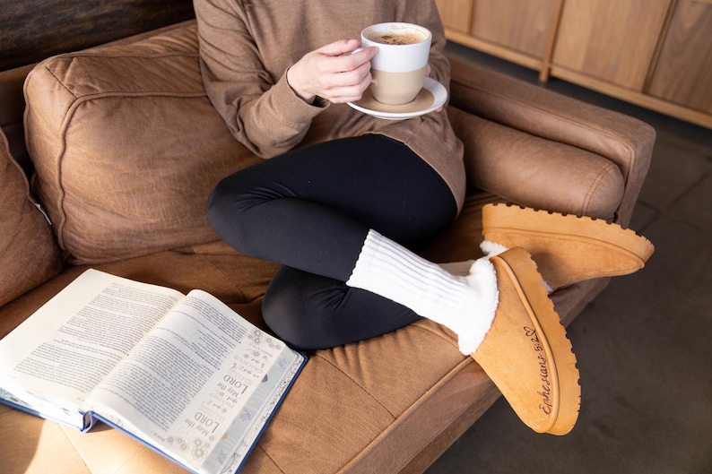 lifestyle photo of cozy scripture slippers with warm shearling lining and engraved Bible verse.