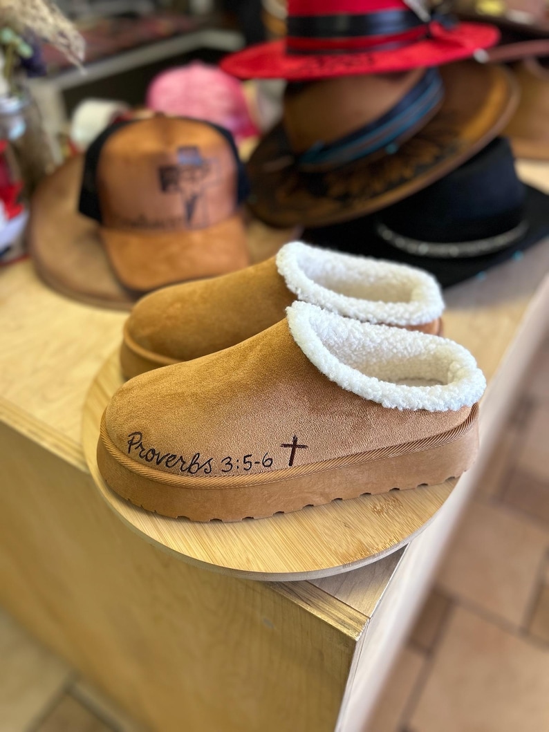 Hand burned Christian Bible verse slippers displayed on wooden stand featuring Proverbs 3:5-6 scripture