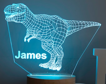May include: A blue light-up dinosaur nightlight with a wooden base. The dinosaur is a wireframe design and the name "James" is engraved on the base.