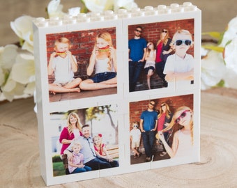 May include: A white Lego-style photo frame with four square images of a family. The top left image shows two children holding watermelon slices in front of their faces. The top right image shows a family of five standing in front of a brick wall. The bottom left image shows a family of four sitting on a bench. The bottom right image shows a girl with sunglasses and a woman with sunglasses.