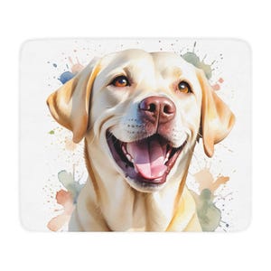 May include: A close-up of a yellow Labrador Retriever dog with a happy expression. The dog is looking directly at the camera with its mouth open and tongue sticking out. The background is a watercolour-style design with splashes of colour.