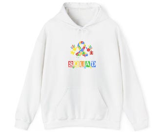 May include: White hoodie with a front pocket and drawstring. The front features a colorful graphic of a puzzle piece ribbon, handprints, and stars, with the word "SQUAD" in a rainbow-colored block font.