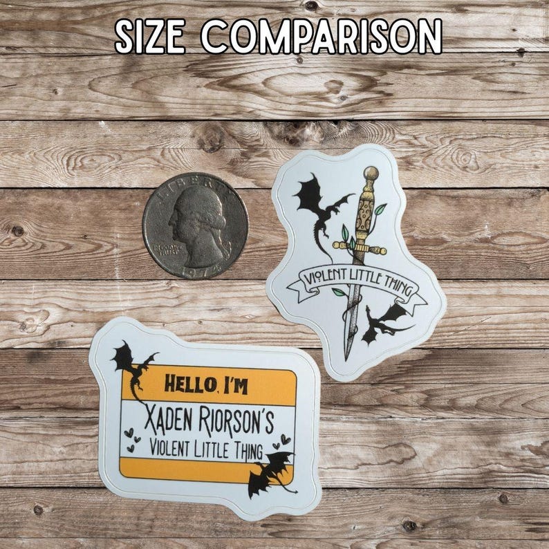 May include: Two stickers with dragon and sword designs, and a quarter for size comparison. One sticker reads "VIOLENT LITTLE THING" with a sword and dragons. The other sticker is a name tag that says "HELLO, I'M XADEN RIORSON'S VIOLENT LITTLE THING".