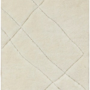 May include: Cream-coloured rug with a diamond pattern. The rug has a soft, textured surface and features a series of diagonal lines that intersect to form diamond shapes. The rug is a neutral colour, suitable for various interior design styles.