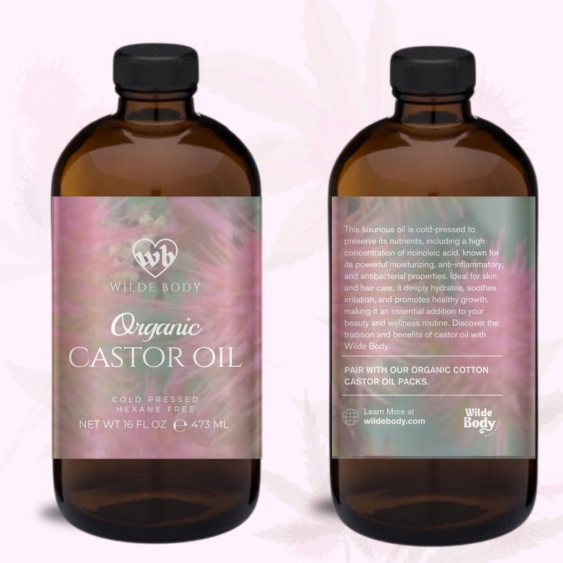 May include: A glass bottle of Wilde Body Organic Castor Oil. The bottle is amber colored and has a white label with pink and green floral designs. The label reads "Wilde Body Organic Castor Oil, Cold Pressed, Hexane Free, Net Wt 16 fl oz e 473 ml".