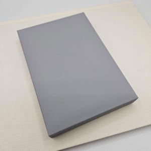 May include: A stack of grey cardstock paper.