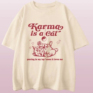 Taylor Swift Karma Is a Cat T-Shirt: Embrace the comfy and fashionable Vibes with this Swiftie Merch shirt. Taylor Swift Eras Tour Shirt Beige