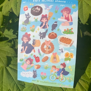 May include: A sticker sheet featuring illustrations from "Kiki's Delivery Service." The sheet includes images of Kiki, Jiji the cat, baked goods, and other elements from the film. The text "Kiki's Delivery Service" is at the top.