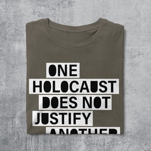 May include: A brown t-shirt with the text "ONE HOLOCAUST DOES NOT JUSTIFY ANOTHER" printed in white.