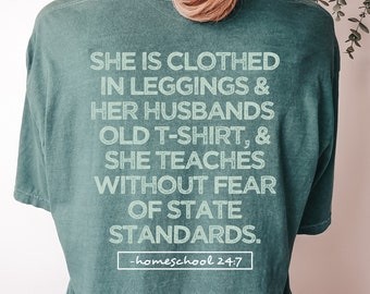 May include: A teal green t-shirt with a white graphic print that reads "She is clothed in leggings & her husbands old t-shirt, & she teaches without fear of state standards. -homeschool 24:7"