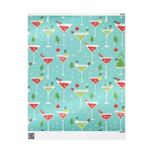 May include: Wrapping paper featuring a repeating pattern of red and green martini glasses on a light blue background. The design includes small green pine trees, white starbursts, and red circular ornaments scattered among the cocktail glasses.