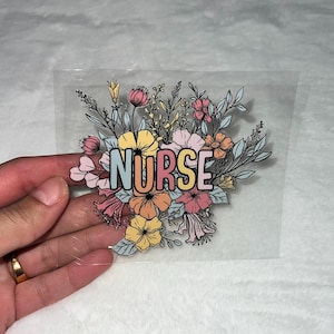 May include: A clear sticker with a floral design and the word "NURSE" in pastel colors.