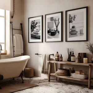 A set of 3 relaxing spa bathroom prints. Featuring minimalist black and white photography, each print showcases a calming scene with candles, towels, and soothing natural elements, displayed on the wall in a calming bathroom setting