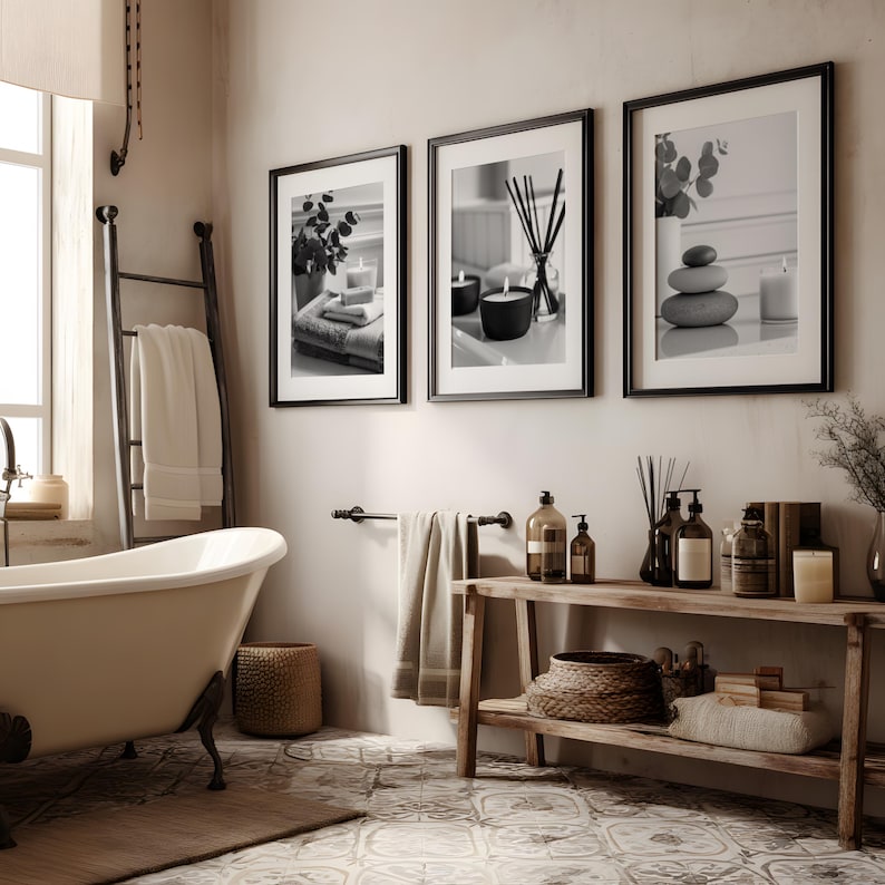 A set of 3 relaxing spa bathroom prints. Featuring minimalist black and white photography, each print showcases a calming scene with candles, towels, and soothing natural elements, displayed on the wall in a calming bathroom setting