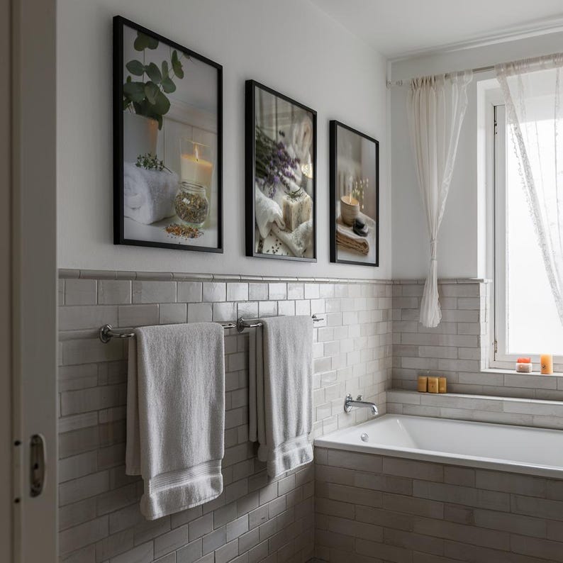 Three framed spa-themed digital prints featuring candles, lavender, eucalyptus, and soap displayed above towel rails in a soft-toned bathroom, creating a tranquil and relaxing home spa decor style.