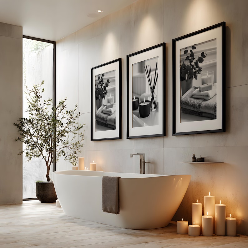 A set of 3 relaxing spa bathroom prints. Featuring minimalist black and white photography, each print showcases a calming scene with candles, towels, and soothing natural elements, displayed on the wall in a calming wellness spa room setting