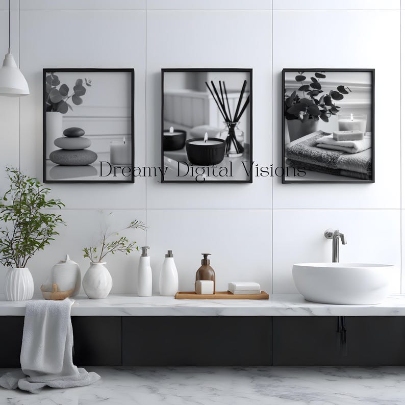 A set of 3 relaxing spa bathroom prints. Featuring minimalist black and white photography, each print showcases a calming scene with candles, towels, and soothing natural elements, displayed on the wall in a calming spa room setting