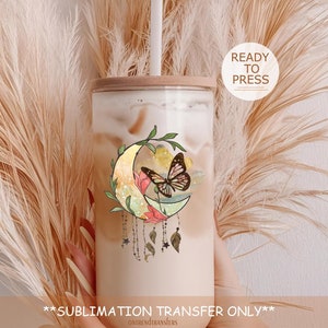 May include: A sublimation transfer design featuring a crescent moon with a butterfly, floral accents, and stars. The design is on a clear tumbler with a wooden lid and a straw. The text "READY TO PRESS" is visible in a circle.