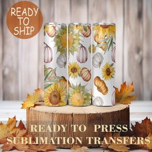 May include: Three sublimation transfer designs featuring a white background with a pattern of sunflowers, pumpkins, and leaves. The designs are ready to press onto tumblers.