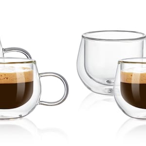 May include: Set of four double-walled glass coffee cups with handles. Two cups are filled with coffee, and two are empty.