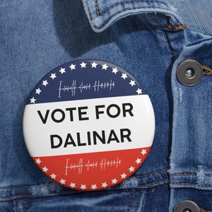May include: A red, white and blue button with stars around the edge. The button says "VOTE FOR DALINAR" in black text.