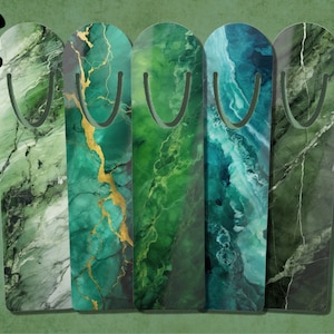 May include: Five green and blue marble-patterned bookmarks with a metal bookmark clip. The bookmarks are arranged horizontally.