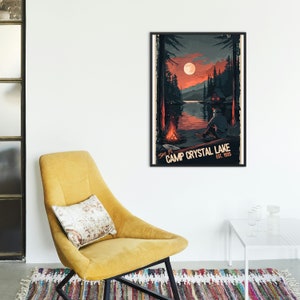 May include: A retro-style poster with a dark blue background featuring a cabin in the woods by a lake. The poster has the text "Stay at Camp Crystal Lake Est. 1935" in white lettering.