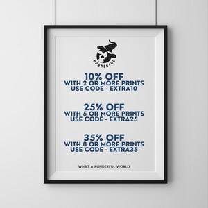 May include: A framed print with a black frame and a white background. The print features a cartoon illustration of a witch wearing a hat and holding a globe. The text on the print reads "Punderful" and offers discounts on multiple prints with the codes "EXTRA10", "EXTRA25", and "EXTRA35".