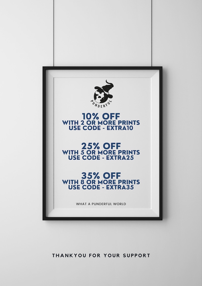 May include: A framed print with a black frame and a white background. The print features a cartoon illustration of a witch wearing a hat and holding a globe. The text on the print reads "Punderful" and offers discounts on multiple prints with the codes "EXTRA10", "EXTRA25", and "EXTRA35".