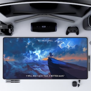 May include: A dark blue and gray gaming mouse pad with a stormy sky background and a silhouette of a person standing on a cliff. The text "IF 1 MUST FALL, 1 WILL RISE EACH TIME A BETTER MAN." is printed on the mouse pad.