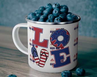 May include: White enamel mug with a red, white, and blue "LOVE" design. The mug is filled with blueberries and has a silver rim.
