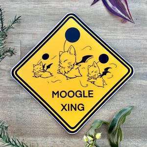 May include: A yellow diamond-shaped warning sign with black text that reads "MOOGLE XING". Three cartoon Moogle characters with wings are flying across the sign. The sign has a black border.