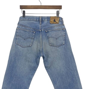 Vintage 80s Levi&#39;s 501 Jeans: Light Wash Distressed Denim, Made in USA (W30 L27.5)