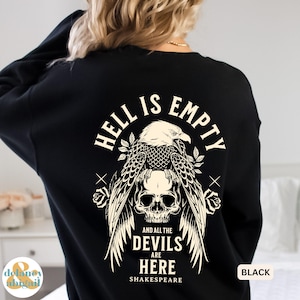May include: Black sweatshirt with a graphic design featuring an eagle, skull, and the text "HELL IS EMPTY AND ALL THE DEVILS ARE HERE SHAKESPEARE." The design is in white. The sweatshirt has a crew neck.