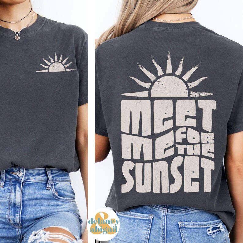 May include: A dark grey t-shirt with a distressed white graphic of a sun and the text "Meet Me For The Sunset".